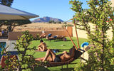 Tourists lounge on the lawn of the Sossusvlei Lodge, just outside entrance of Namib-Naukluft National Park.