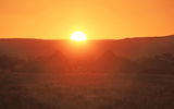 Huts silhouetted at sunset in Namib-Naukluft National Park.