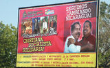 Daniel Ortega and Hugo Chavez embrace on a billboard.