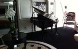 A baby grand piano in the Music Room of one of four Owner's Suites.