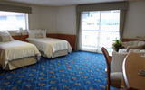 Decorated with blue carpeting and white furniture, the cabins feel spacious and bright, some with large windows, and balconies in all but 12 of the cabins.