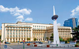 In the background, the former headquarters of the Romanian Communist Party in Bucharest where Nicolae Ceausescu held his infamous final speech on Dec. 21, 1989. In the foreground, the Revolution Memorial. Photo by ncristian/shutterstock