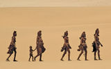 Himba women make their way through the Namibian desert with a child. Photo by Dana Allen/Wilderness Safaris