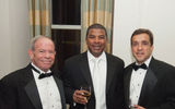 Cheers: Warren Cohen, left, and Dwight Johnson, center, of Sandals Resorts International, share a Readers Choice Awards toast with George Lanzaro of Rocky Mountaineer.
