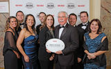 Mandy Chomat, center, vice president of sales and marketing at Karisma Resorts, is joined by his wife, Christina, fifth from left, and sales team in accepting the Mexican hotel group's fourth consecutive win for Hotel Chain: Boutique.