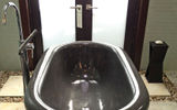Bathtubs in many shapes and sizes are a feature of the guestrooms at Sandals LaSource; this tub in a Millionaire Suite in the South Seas Village was cut from a single block of black marble.