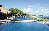 The adult side of Nizuc Resort & Spa features an infinity pool, flanked by sun lounges and the adjacent Punta Grill.