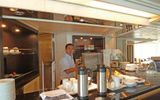 The Yacht Club includes a kitchen and service counter that provides coffees, sweets and light sandwiches.