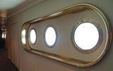 These portholes in a corridor leading to the Compass Rose provide an underwater view of the swimming pool. They had been covered over when Windstar took possession of the ship from Seabourn.
