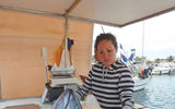The fish vendors donate the head of the tuna, which will be used to make a fish soup for the galley crew.