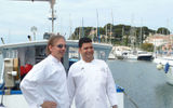 Chefs Michael Sabourin and Rohit Dimri in front of the boat that caught the evening's tuna dinner.