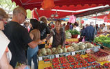 French shoppers crowd the narrow spaces between the stalls at the Sanary-Sur-Mer weekly market.