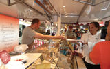 Chef Michael Sabourin gets cheese samples on waxed wrapping paper.