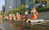 Figures, made of traditional Korean paper, floating on Seoul's Cheonggye Stream. Effectively oversized lanterns, these floats were part of a temporary special exhibit.