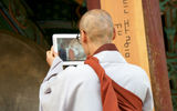 A Haeinsa monk captures his colleague's drumming skills on film, for training purposes.