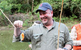 Scott Bahr, vice president of product development and strategic alliances for Marriott Vacations Worldwide, displays a small piranha he caught.