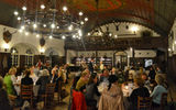 Inside the Stiegl Keller, guests find their seats and prepare for a meal of traditional Austrian culinary dishes.