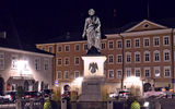 Guests pass the statue of Salzburg-born composer Wolfgang Amadeus Mozart as they make their way to meet the transfers back to their hotels.