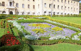 The papal coat of arms, planted in flowers, in front of the central administrative building.