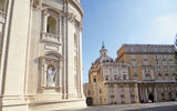 The rear of the dome of St. Peters peeks over buildings that form a different square within Vatican City.