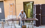 A Roman carpenter pauses in his work to watch the Tauck group go by.