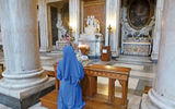 A sister prays in Santa Maria Maggiore church.