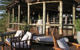 Terrace at Sanctuary Olonana, which accommodates tables for outdoor dining and overlooks the Mara River. The tented camp is located on the Transmara Conservancy abutting the Maasai Mara National Reserve.