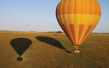 View from a hot-air balloon over the Maasai Mara. These balloons, operated by Balloon Safaris, Ltd., are about to land, just in time for and within a few yards of breakfast in the bush.