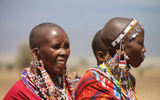 Maasai women, adorned with traditional beaded earrings and necklaces, were among villagers welcoming visitors to their home near Amboseli National Park.