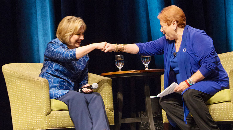 Former Secretary of State Hillary Clinton, left, and Greater Fort Lauderdale Convention & Visitors Bureau President Nicki Grossman share a fist bump at the recent ASTA Global Conference in Miami during a Q&A session conducted by Grossman. In her closing session speech, Clinton praised travel agents, calling them “dream makers,” and talked about the importance of travel in bringing cultures and people together to improve global understanding.