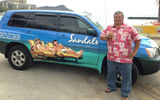 Derek Peterson of Global Pursuits show off his newly wrapped Sandals Resorts car on the beach in Waikiki. Peterson was introduced to the Sandals Resorts and Beaches Resorts brands in June 2012 at a Buck Wilson Travel trade show in Honolulu.  He has received more than a year’s worth of training on a number of products via various seminars and has set a goal of becoming Hawaii’s top Sandals Resorts and Beaches Resorts producer.