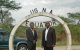 Two Ugandan tourists, one in the Northern Hemisphere and one in the Southern, pose on the equator.