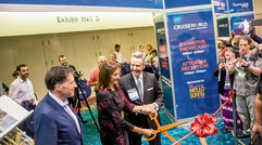 Dondra Ritzenthaler of Celebrity Cruises wielded the scissors to cut the ribbon to officially open the exhibitor showcase with Travel Weekly Editor in Chief Arnie Weissmann, left, and Publisher Bruce Shulman.