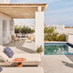The resort's cliffside location provides panoramic views of the Aegean Sea. Shown here is a Premier Executive Suite.