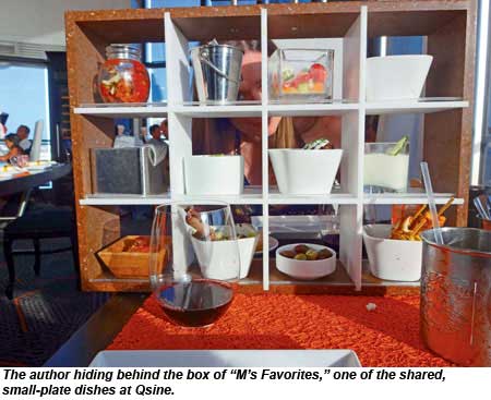 The author hiding behind the box of Ms Favorites, one of the shared, small-plate dishes at Qsine.