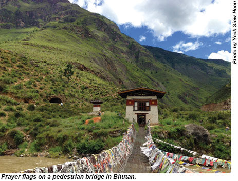 Prayer flags on a pedestrian bridge in Bhutan.