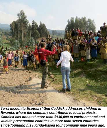 Terra Incognita Ecotours Ged Caddick addresses kids in Rwanda.