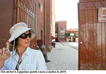 The writers Egyptian guide casts a ballot in 2011.