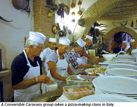 A Convertible Caravans group takes a pizza-making class in Italy.