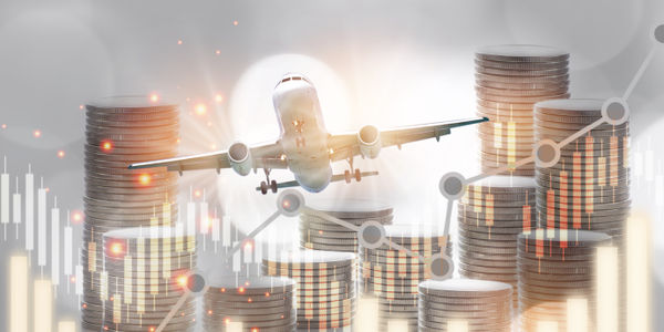 Airplane business recovery concept and business travel idea. Stack of coins and growth graph on aircraft transportation background