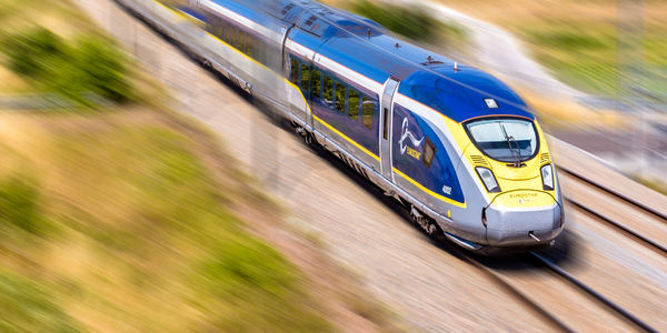 Baron, France - July 29, 2020: A Eurostar e320 high speed train is driving at full speed in the french countryside (artist's impression).