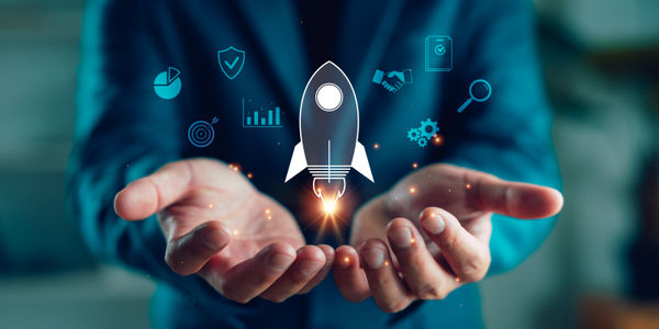Businessman hands holding rocket icon with digital business elements, symbolizing startup launch, innovation, growth strategy, entrepreneurship and future success in modern business.