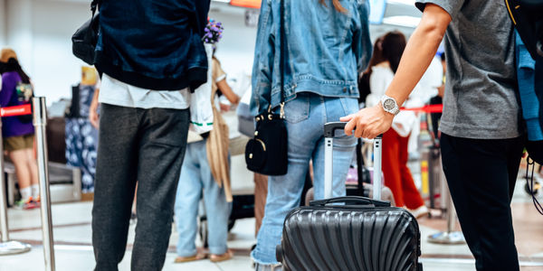 people waiting for check in at airport. A man and luggage at the airport terminal.