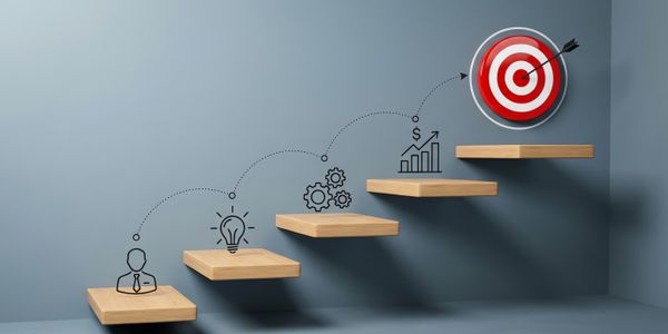 A wooden staircase ascends toward a red and white bullseye target on a blue wall.
