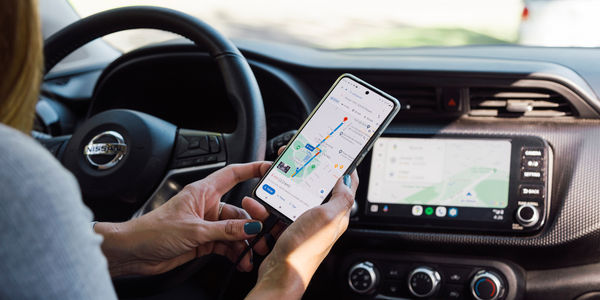 Searching for a route in the GPS app. Woman in a car connecting Google Maps from the mobile phone to the car computer. ROSARIO, ARGENTINA - MARCH 22, 2024.