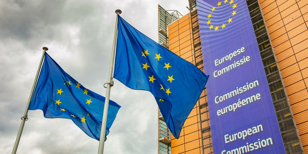 Brussels, Belgium-12 October, 2022: Gloomy sky and European Union flags, Europe crisis concept