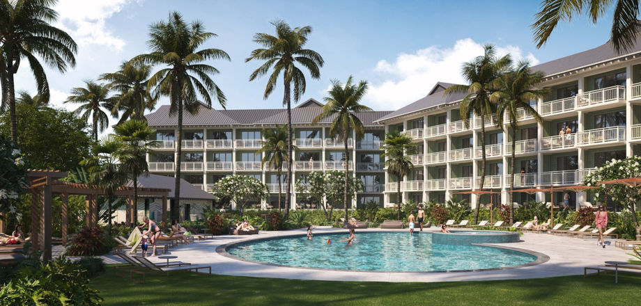 Circular blue pool surrounded by palm trees in a sunny resort courtyard.