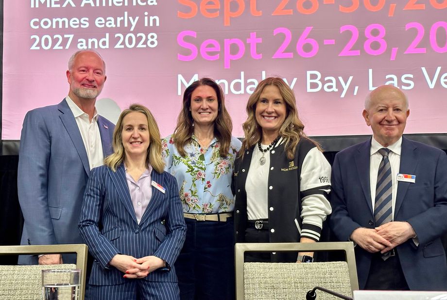 Five professionals stand together on a conference stage: IMEX Closing Press Conference (left to right): Steve Hill, CEO, LVCVA; Carina Bauer, CEO, IMEX; Rachel Benedick, chief revenue officer, MPI; Stephanie Glanzer, CSO and senior vice president, MGM Resorts; Ray Bloom, chair, IMEX Group
