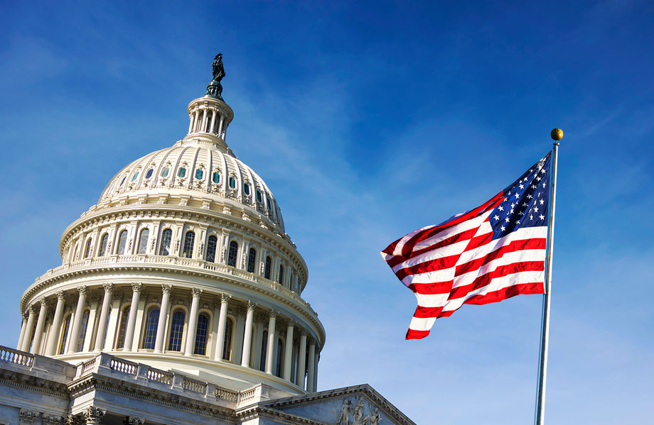 American flag waving with the Capitol Building in the background