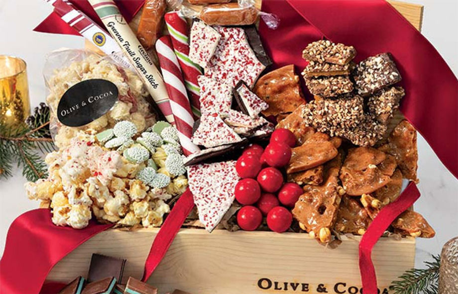 A festive crate from Olive and Cocoa overflows with assorted cookies and confections.